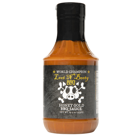 Bottle of Honey Gold Sauce with a black cap on a white background